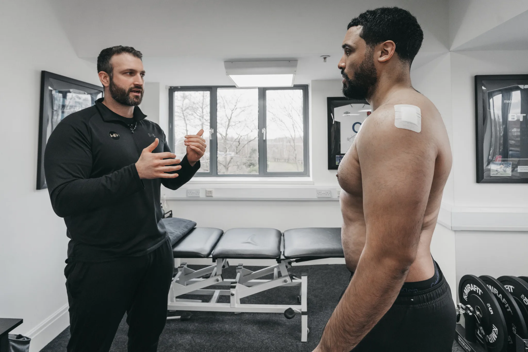 Patient discussing injury with physiotherapist