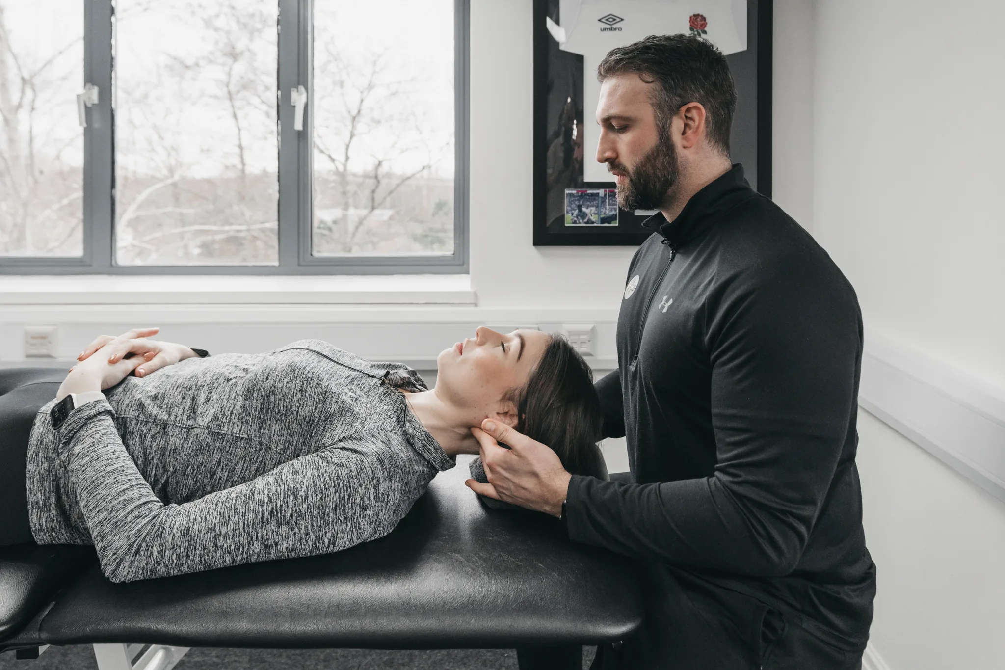 Physiotherapist assessing a patient